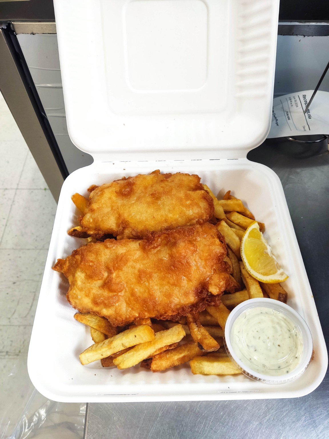 Fish and chips with lemon and sauce