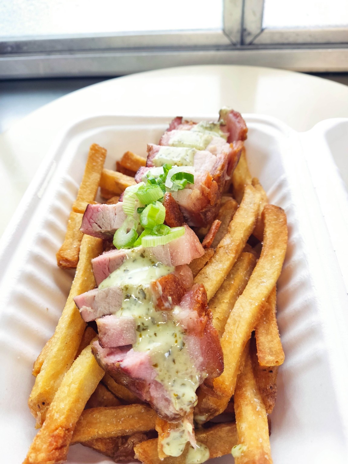 Fries topped with smoked meat and sauce